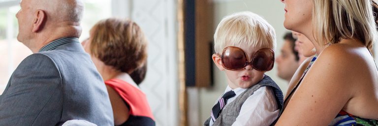 Boy at a wedding in sunglasses