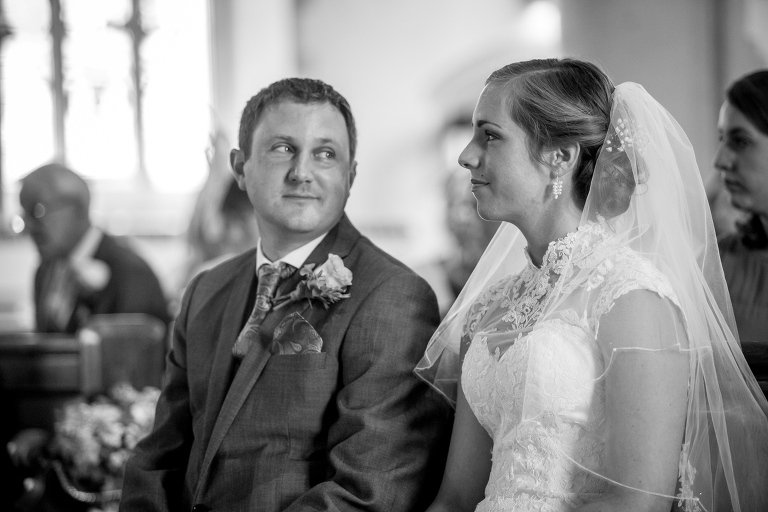 Groom catching a look at his bride