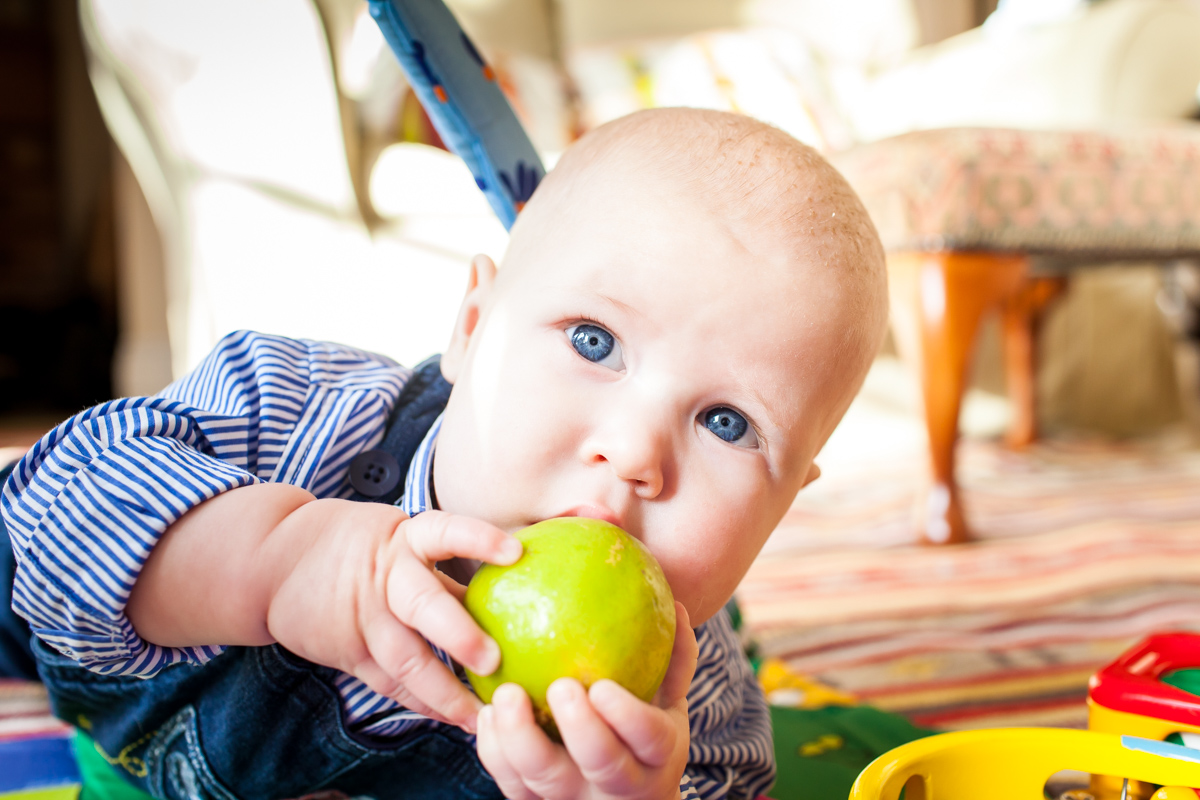 Little boy eating a whole lime