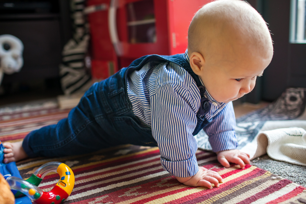 Little boy learning to crawl