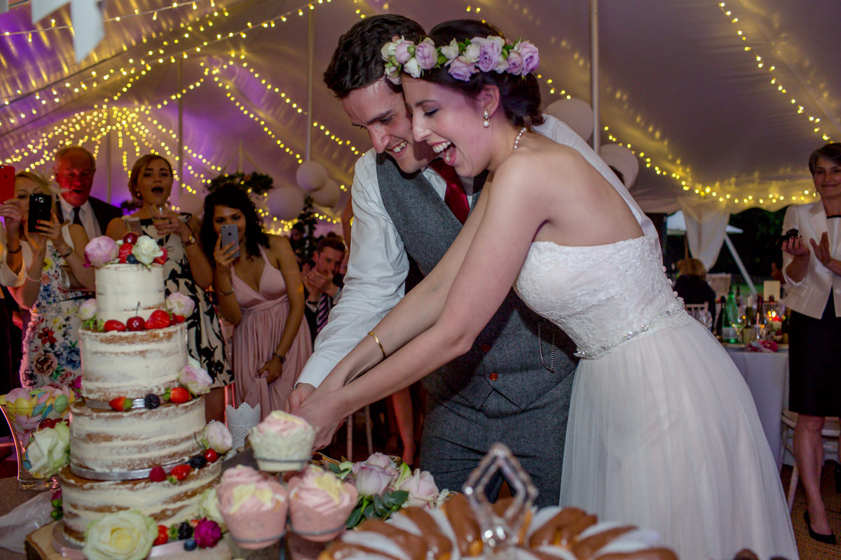 Bride and groom cutting cake